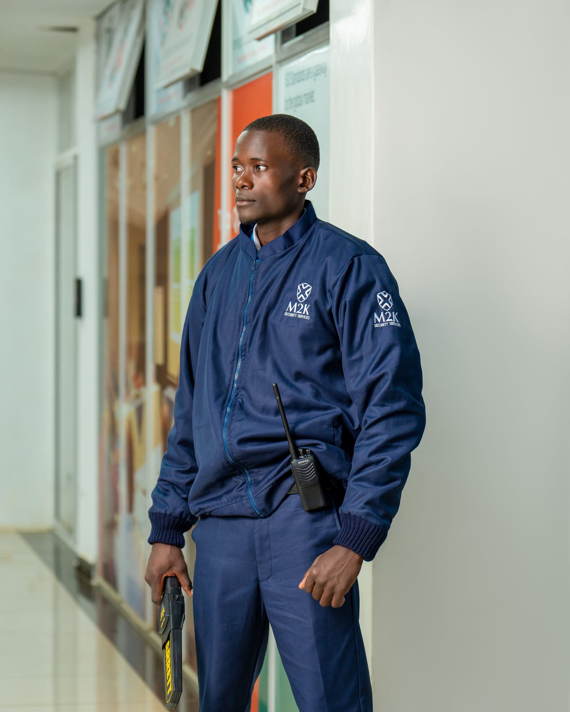 M2K guard in branded navy uniform standing on duty