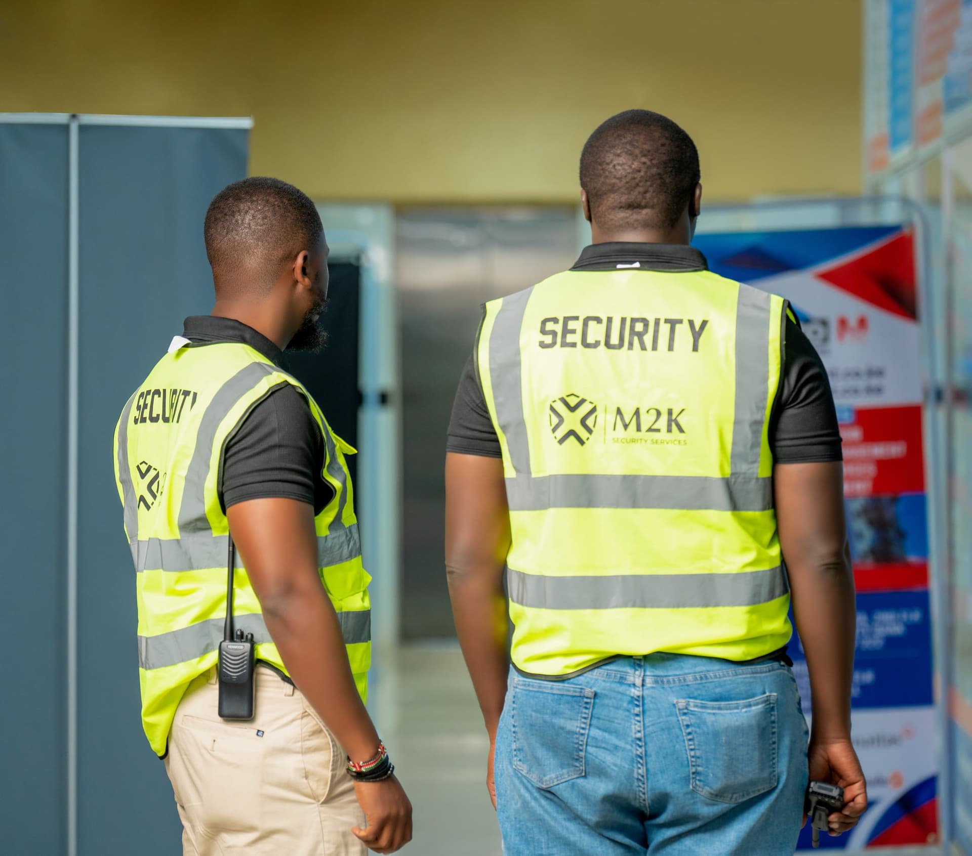 M2K guards on patrol in hi-vis vests inside a corporate building